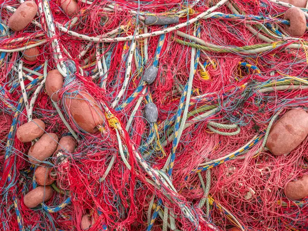 Red fishing nets on the pier.  Textured background of fishing nets close-up.