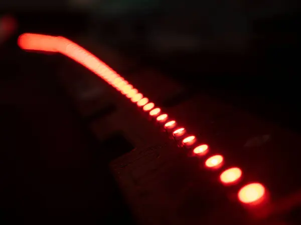 Red led strip on a black background. Selective focus. Shallow depth of field