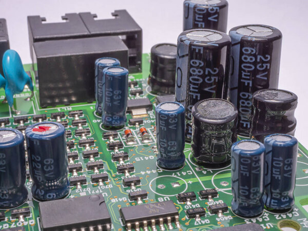 Green circuit board with electronic components. Selective focus. 