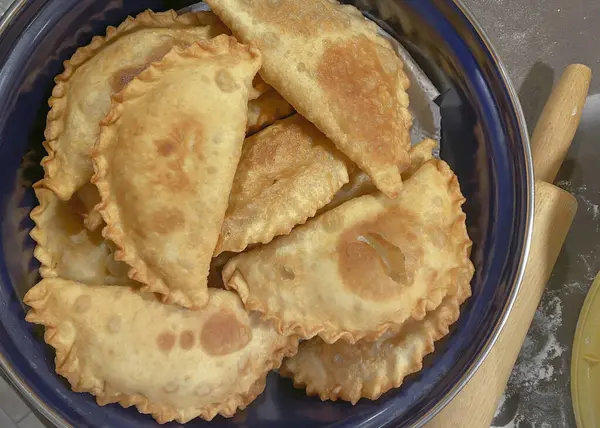 stock image Chebureki - pan fried pies with meat and onions in a pan