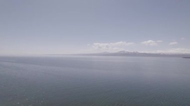 Cold Lake in the Caucasian Mountains. Wavy Lake Between Snowy Mountains. Sevan, Armenia.
