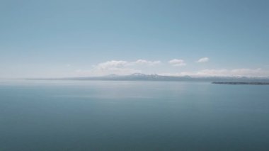 Cold Lake in the Caucasian Mountains. Wavy Lake Between Snowy Mountains. Sevan, Armenia.