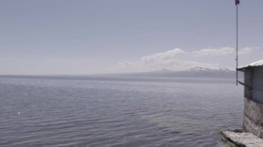 Girl Standing on a Coast of a Cold Lake. Beautiful Girl. Sevan, Armenia. Sevan Lake. Winter. Mountain Lake.