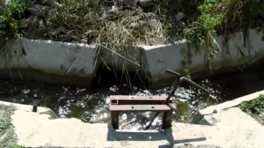 A muddy river with brown water. Slow current. A muddy river during a winter flood. dirty river. Dirty water of muddy river in flooding period during heavy rains in spring.