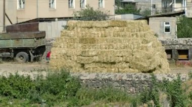 Hay in the Garden. Hay parallelepipeds well stacked on each other. Agriculture, farming, harvesting concept.