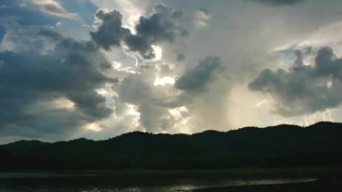 Tayland 'da su kaynağı olarak kullanılan büyük bir doğal ya da yapay göl üzerinde bulutların hızlanması ve gün batımı.