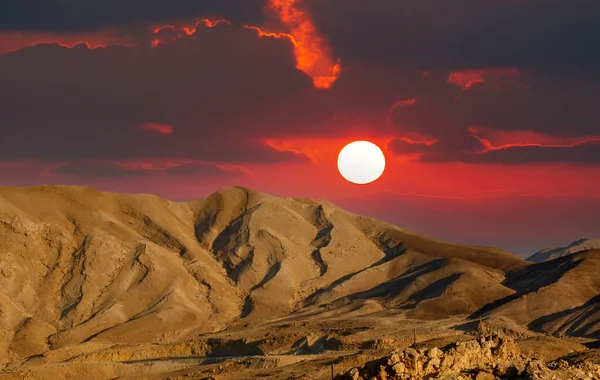 Red sunset on a foggy mountain range Sodom. Evening red sunset sky over mountain Sodom Gomorrah in Dead sea from Negev desert. The mountains of Sodom located on the south-west side of the Dead Sea.