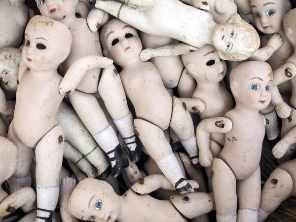 Old and dirty ceramic doll sculpture