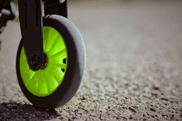 Rolling on Asphalt: A Close-Up View of the Scooter Wheel