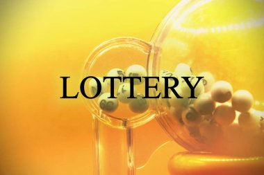 Process of prize drawings, extracting a winning numbers of lottery machine, raffle drum with a bingo balls and winning tickets on event with a host and hands on lottery machine