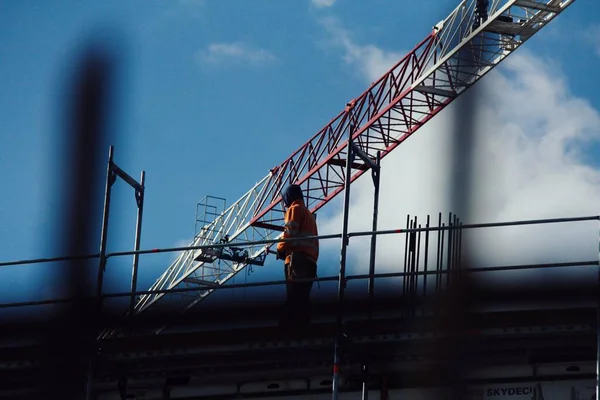 Construction worker at work with a blue sky as background