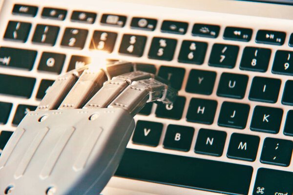Robotic hand typing on a keyboard . Concept of future and AI.
