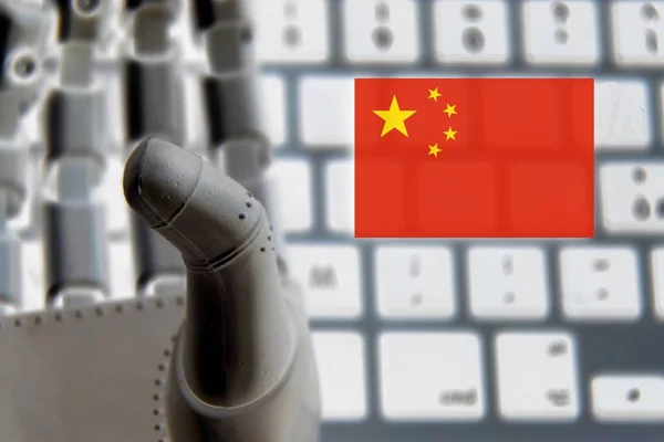 Robot hand with a China flag as a background . Concept of Chinese investments on robotics .