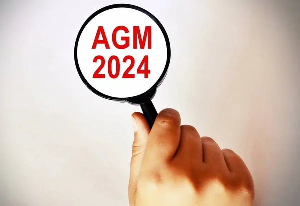 Magnifying Glass 3d Illustration showing AGM 2024. Annual general meeting 2024.