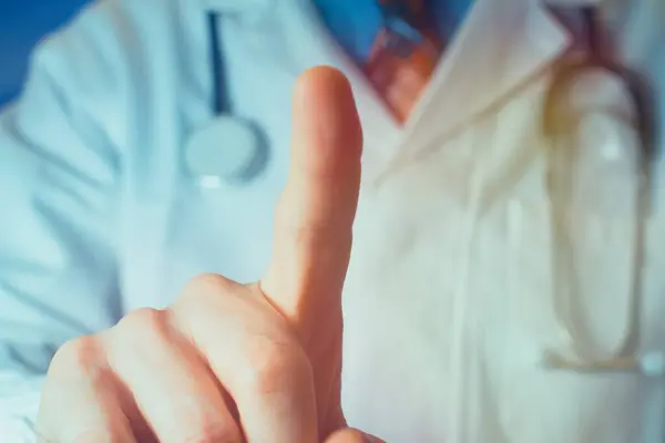 Close up of a doctor pointing finger up