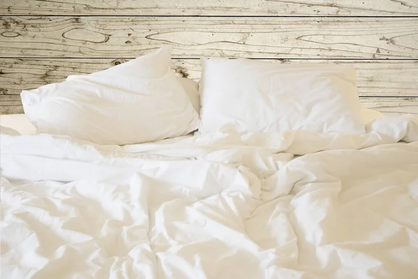 Close up white bedding sheets and pillow, Messy bed concept