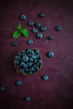 Fresh berries, Blueberries, on a maroon background, food concept, vertical, no people,