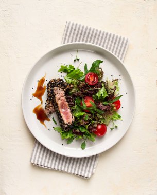 Vegetable salad, with fried tuna, in sesame seeds, healthy food, top view,