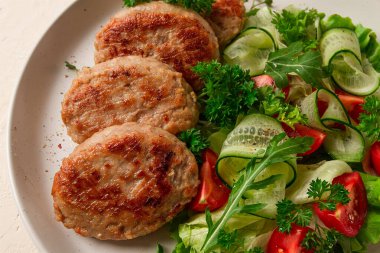 Fried cutlets, turkey, with vegetable salad, top view, no people,