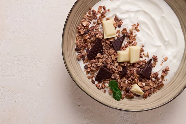 yogurt with chocolate muesli, breakfast, close-up, fork on top, no people,