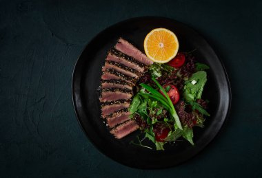 Vegetable salad, with fried tuna, in sesame seeds, healthy food, top view,