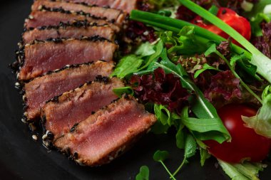 Vegetable salad, with fried tuna, in sesame seeds, healthy food, top view,