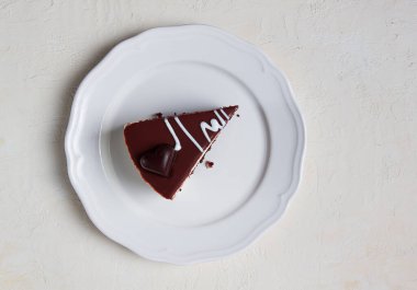 slice of cake, bird's milk, chocolate sponge cake with souffle, sweet dessert, on a white plate, close-up, horizontal, no people,