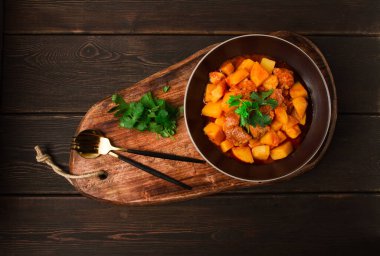 Potatoes stewed with meat, in tomato sauce, with spices and herbs, no people,