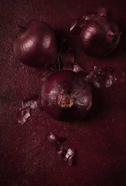 Red onion, fresh, raw, on a dark background, top view,