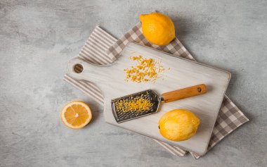 Grated lemon zest, on a cutting board, with a grater , top view, no people,