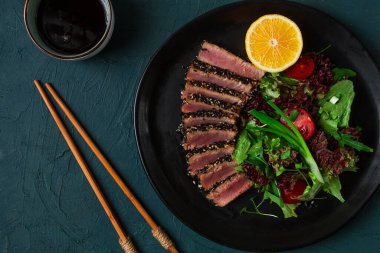 Vegetable salad, with fried tuna, in sesame seeds, healthy food, top view,