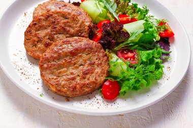 Fried cutlets, turkey, with vegetable salad, top view, no people,