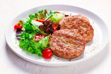 Fried cutlets, turkey, with vegetable salad, top view, no people,