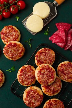 Mini pizzas, salami with mozzarella cheese, on the table, top view, no people,