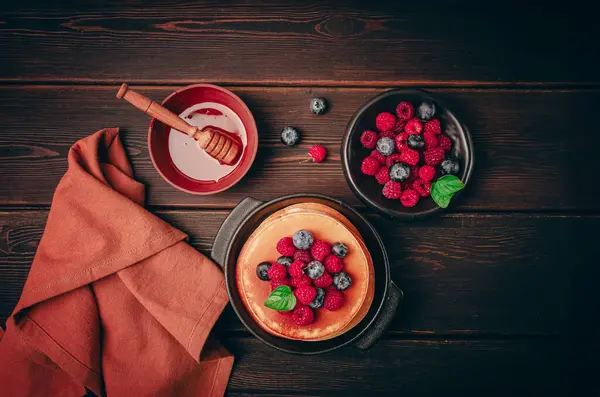 stock image Breakfast, pancakes with berries and honey, top view, homemade, no people, on a wooden background,