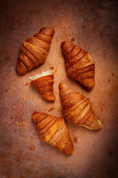 Stock image fresh croissants, breakfast, top view, on the table, brown background, no people,