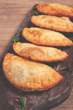 Kızarmış cheburekler, kızartılmış mini kıyma tahtası, ahşap masa, yakın plan, insan yok.,