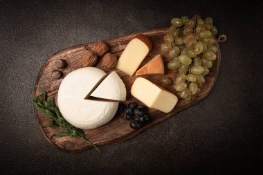 Georgian cheese, Imeretian and smoked suluguni, grapes, nuts, on a cutting board, Georgian cuisine, no people, clipart