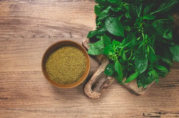 stock image ground green basil, in a ceramic bowl, with a bouquet of fresh green basil, on the table, top view, no people,