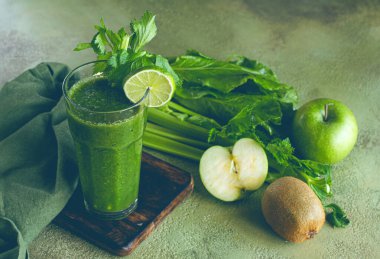 glass, with green smoothie, celery and spinach, apple and kiwi, cucumber, with ingredients on the table, vegetable smoothie, breakfast, homemade, no people, clipart