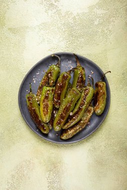 fried padron pepper, in a frying pan, with olive oil, and sea salt, homemade, no people. clipart