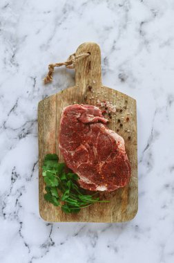 raw pork steak , pork neck, on a chopping board, marble table, top view, with spices and coriander, no people, clipart