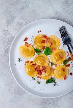 Taze ravioli, tereyağlı, baharatlı ve otlu, kızarmış pastırmalı, masada, üst tarafta, arka planda, insan yok.,