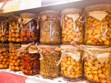 Çeşitli fındık ve tohumlarla dolu kavanozlar mağaza rafında sergileniyor, insan yok, mobil fotoğraf,