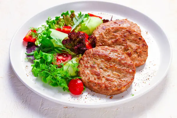 Fried cutlets, turkey, with vegetable salad, top view, no people,