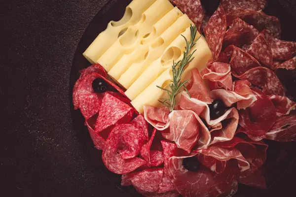 Pirzola, aperatif, prosciutto, salam ve jambon, maasdam peyniri ve zeytinli, yuvarlak tabakta, kahvaltı, üst manzara, yakın çekim, terk edilmiş
