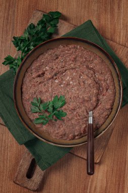 Red bean lobio,a traditional Georgian dish, on a wooden table, homemade,