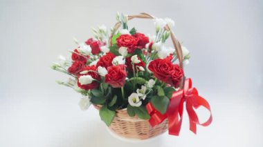 Bouquet of flowers in a basket rotates on a white background