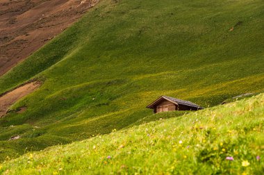 Wooden small cabin in Italian Dolomite Alps mountains
