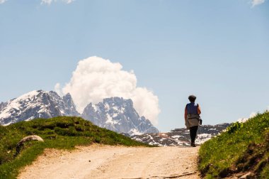 Hiker in mountains, beautiful scenic landscape of Alps, Passo San Pellegrino, North Italy